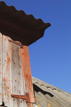 The roof of the house is covered with slate with a wooden door to the attic