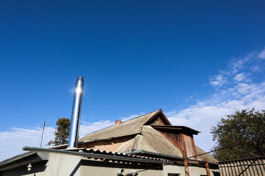 The roof of the house is covered with slate on a background of sky