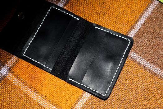 Leather wallet stitched with white threads on