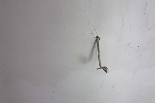 White wire sticks out of the wall