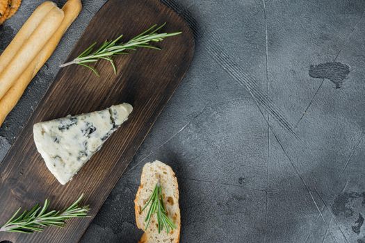 Appetizers table with differents antipasti set, on gray background, top view with copy space for text