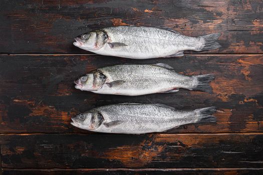Seabass on old fisherman wooden table top view space for text