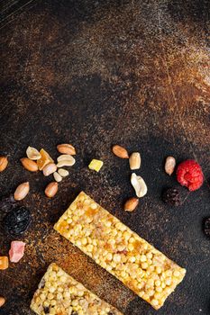 Granola bar with raisins and berry, top view with copy space, on old dark table