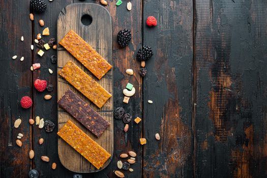 Dried fruits energy bars, flat lay with space for text, on wooden table