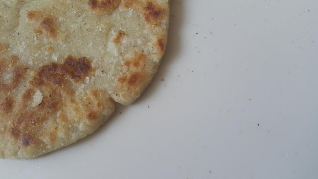 Closeup view of of traditional bread called Jawar roti or bhakri on white background. Bhakri is a round flat unleavened bread often used in the cuisine of many Asian countries