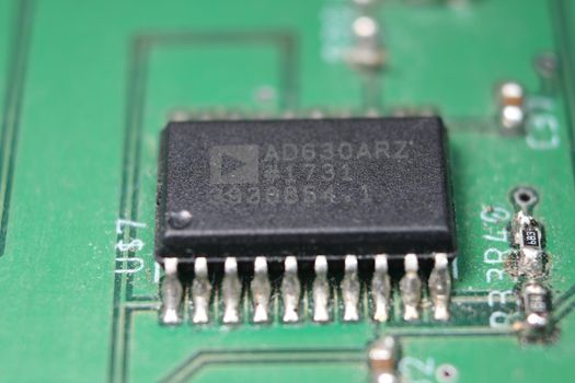 Electronic board with circuit lines and chip. Macro view of green board