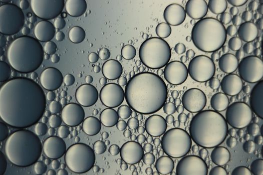 abstract macro background of oil circles floating over water surface . Macro closeup view of bubbles on water . oil bubbles in the water macro photographic background