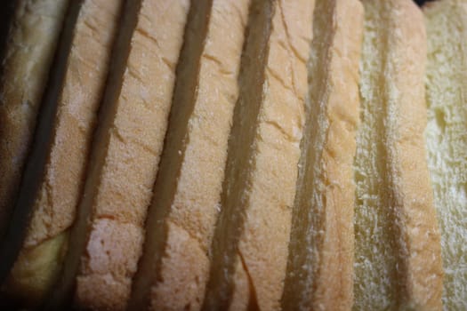 Closeup top view of freshly prepared slices of toast bread. Food background for bakery products