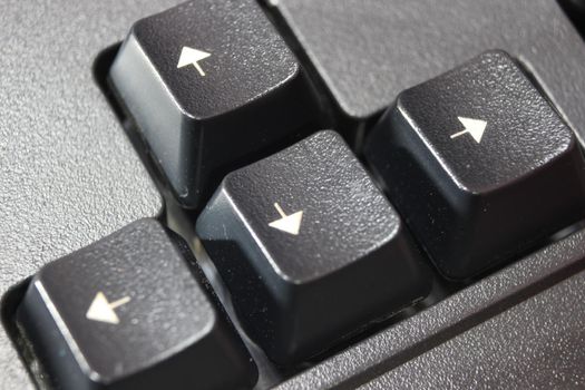 Closeup of laptop computer keyboard black keys with white letters and numbers. Black keys with white characters.