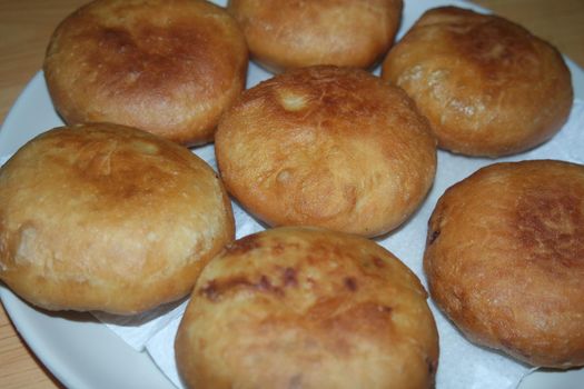 Closeup view of homemade tasty potato bread rolls bun placed over white tissue paper.