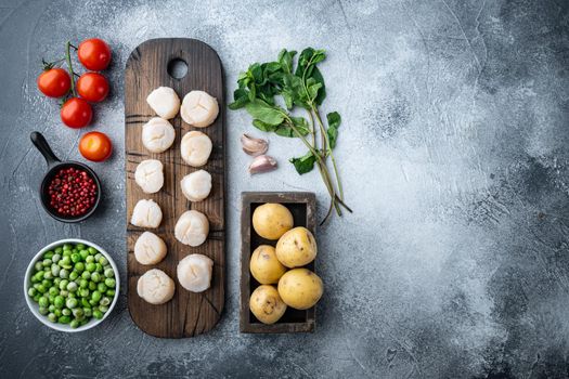 Sea delicacies, scallops with potato, green pea and mint, top view, on grey background with copy space