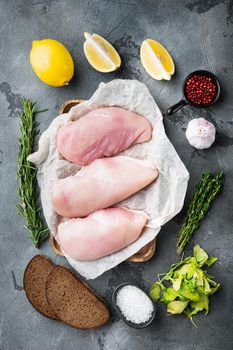Crumbed uncooked chicken breasts ingredient on grey background, top view