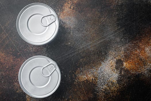 Canned sauce tin can, on old dark rustic background, top view or flat lay with copy space for text