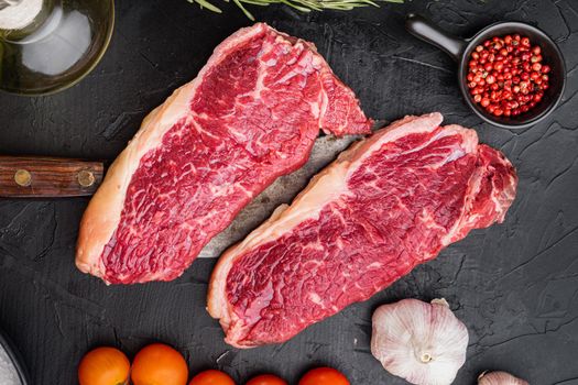 Top sirloin beef steaks cut, on black background, top view