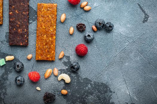 Fruit berry nut energy bars, healthy snack, top view with copy space, on grey background