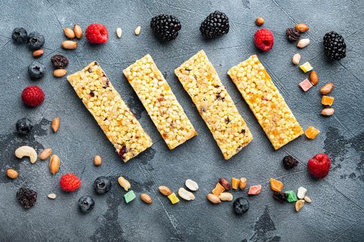 Granola bar with raisins and berry, top view, on grey background