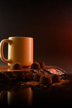 A composition of coffee and fine chocolate truffles for a tasteful display.