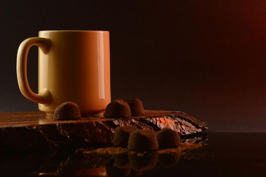 A composition of coffee and fine chocolate truffles for a tasteful display.