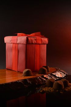 A red gift box and fine chocolate truffles to set a romantic scene.