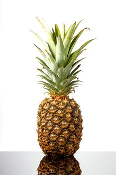 Ripe, Fresh Fruit pineapple on black glass table on white background