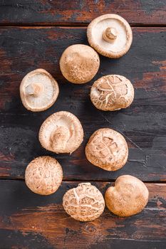 Shiitake mushrooms set on old wooden table, top view
