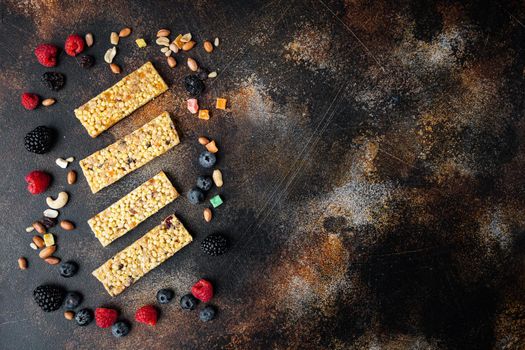 Raw organic granola bar with seeds and nuts, top view with copy space, on old dark table