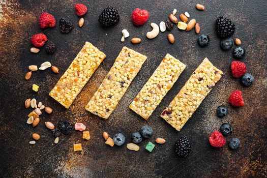 Granola energy bars with nuts, seeds, berry, top view, on old dark table