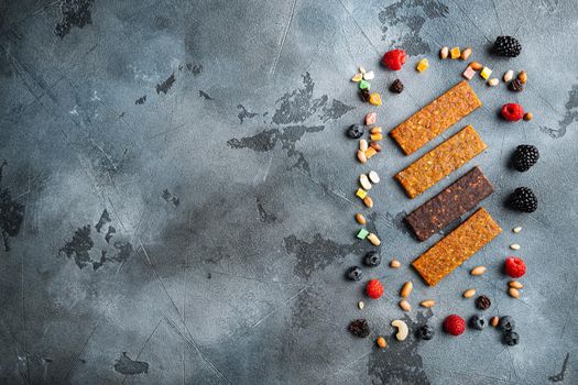 Fruit berry nut energy bars, healthy snack, top view with copy space, on grey background