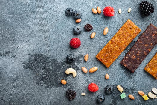 Dried fruits energy bars, top view with copy space, on grey background