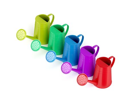 Colorful watering cans on white background