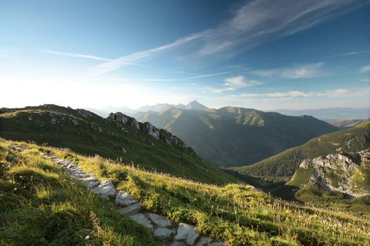 Trail among the peaks in the Carpathian Mountains at dawn.
