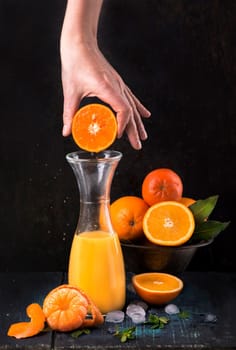 glass of fresh orange juice with fresh fruits on wooden table