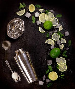 Bar accessories and ingredients for cocktail drink lime, mint, ice.