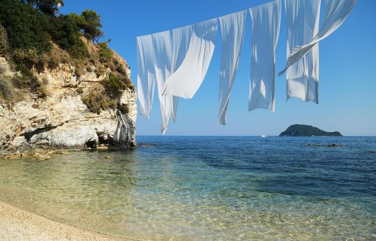 Summer beach with sand, sea and white sail. Summer vacation travel holiday background concept. Greece Zakynthos
