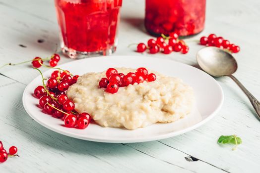 Simple and healthy breakfast with porridge and infused water with berries