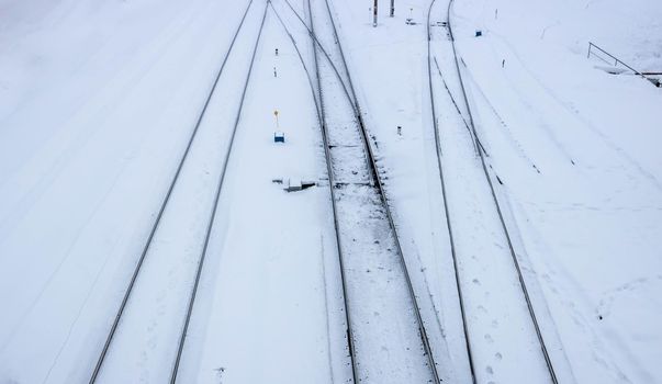 Winter railway road with white snow. Rails in the snow.