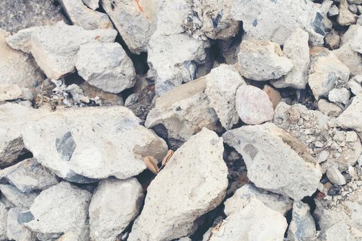 broken concrete floor at building construction site. cracked concrete texture background. Grey surface with cracks close up. A lot of pieces of splintered plaster. Abstract concept of split, dissent,