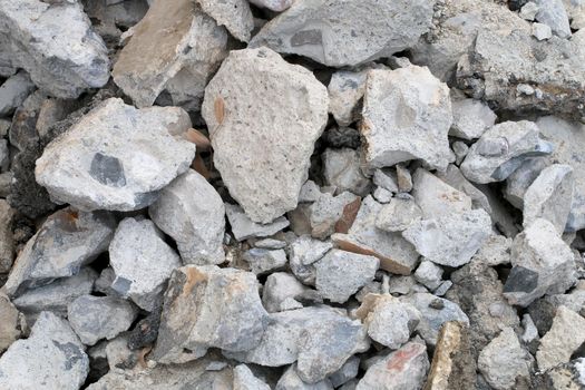 broken concrete floor at building construction site. cracked concrete texture background. Grey surface with cracks close up. A lot of pieces of splintered plaster. Abstract concept of split, dissent,