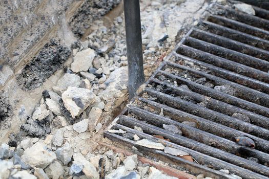 Male workers use electric concrete breaker for digging and drilling concrete repairing driveway surface with jackhammer at the local city road, during sidewalk, work construction site.