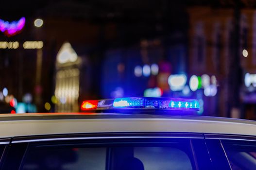 police car lights at night in city with selective focus and bokeh blur