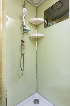 At the back wall of the shower stall on which the mixer and shower are located the glass cracked