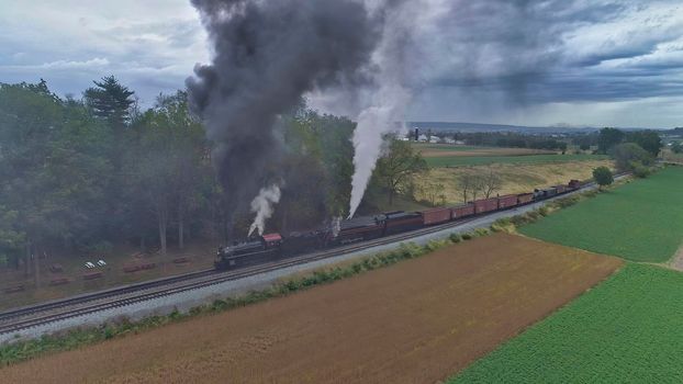 Aerial View of 2 Restored Antique Steam Engines and Double Heading and Steaming Up at a Small Rail Road Station