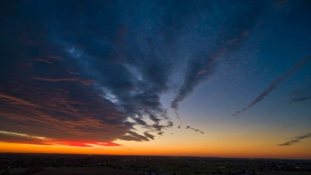 Aerial View of a Cloudy Red and Orange Sunset in the Fall