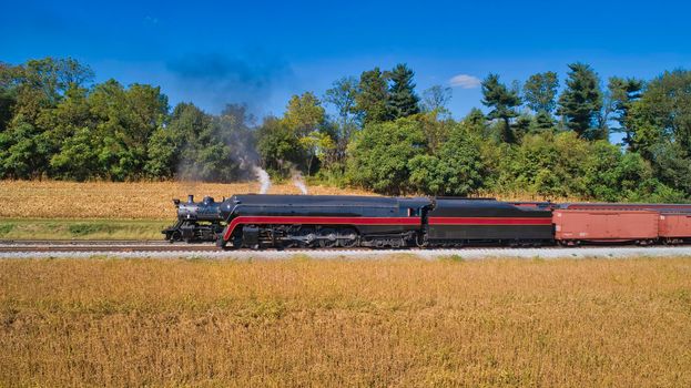 Aerial View of 2 Restored Antique Steam Engines and Passenger Cars Steaming Up at a Small Rail Road Station