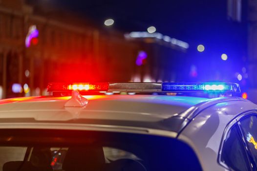 police car lights at night in city with selective focus and bokeh blur