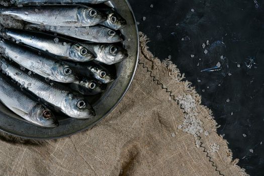 Raw fresh fish. Black background. Top view