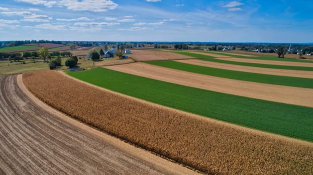 Aerial View of Multiple Farms and Train Tracks going Thru Them on a Beautiful Summer Day