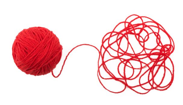 The idea is a tangled thread. Red ball of yarn on white background