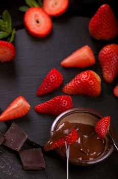 Composition with chocolate covered strawberries on grey background