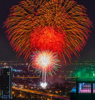 Colorful Firework with cityscape night light view of Bangkok skyline at twilight time. New Year celebration fireworks, Bangkok city,Thailand Fireworks light up to sky at Christmas & New Year festival with free space for text. No focus, specifically.